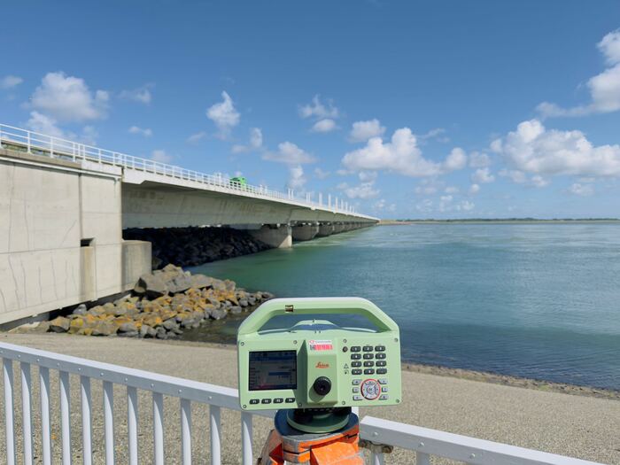 Totalstation op een brug boven het water tijdens een controlemeting